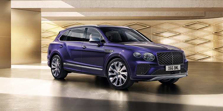 Bentley Melbourne Bentley Bentayga Extended Wheelbase Mulliner SUV front three quarter in Tanzanite Purple paint with a gold patterned background