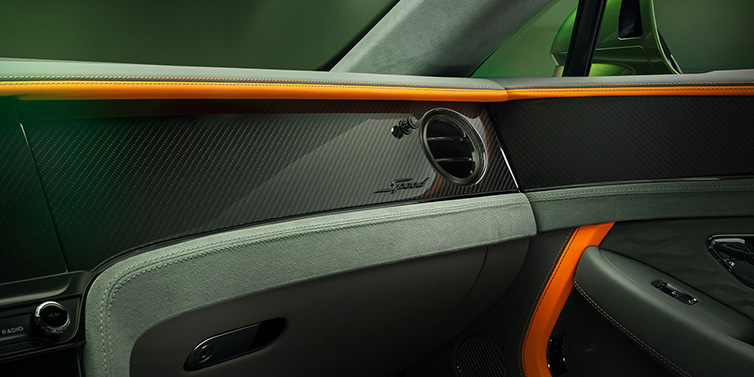 Bentley Melbourne Bentley Continental GT Speed coupe front interior dash detail with high gloss carbon fibre veneer surrounded by Mandarin by Mulliner and Gravity Grey hides