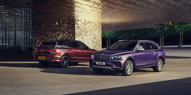 Bentley Melbourne A duo of Bentley Bentayga Extended Wheelbase Mulliner SUVs parked in a city environment, with Tanzanite Purple and Cricket Ball red exterior paint