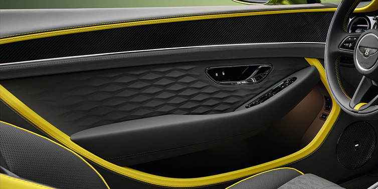 Bentley Melbourne Bentley Continental GTC Speed convertible interior door details featuring Gravity Grey and Cyber Yellow by Mulliner hides and high gloss carbon fibre veneer