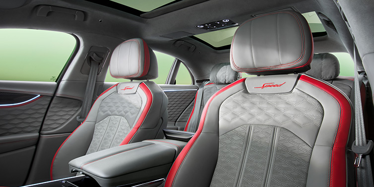 Bentley Melbourne Bentley Flying Spur Speed sedan interior showing front and rear seats in Hotspur red and Gravity Grey hides, with Speed seat emblems