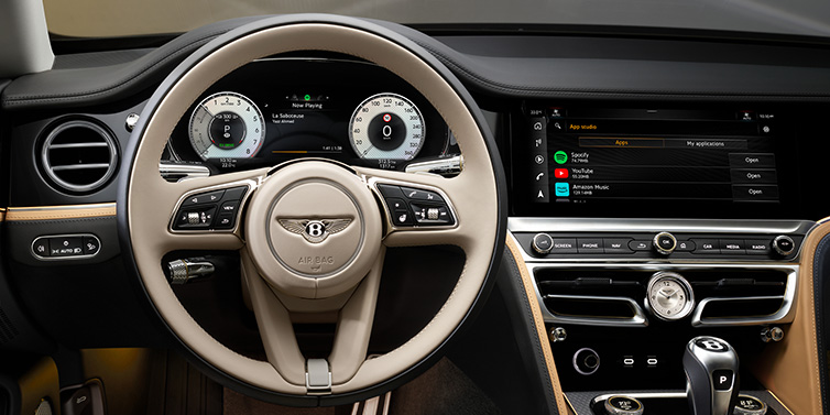 Bentley Melbourne Bentley Flying Spur Mulliner sedan front interior detail of steering wheel and driver screens surrounded by Linen and Beluga black hides