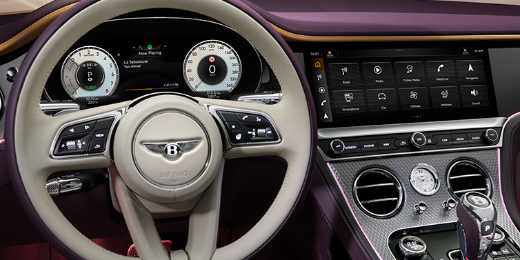 Bentley Melbourne Bentley Continental GTC Mulliner convertible steering wheel and drivers screens surrounded by Damson purple and Linen hides